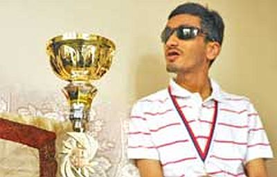 Visually impaired chess player Darpan Inani shows his opponents he